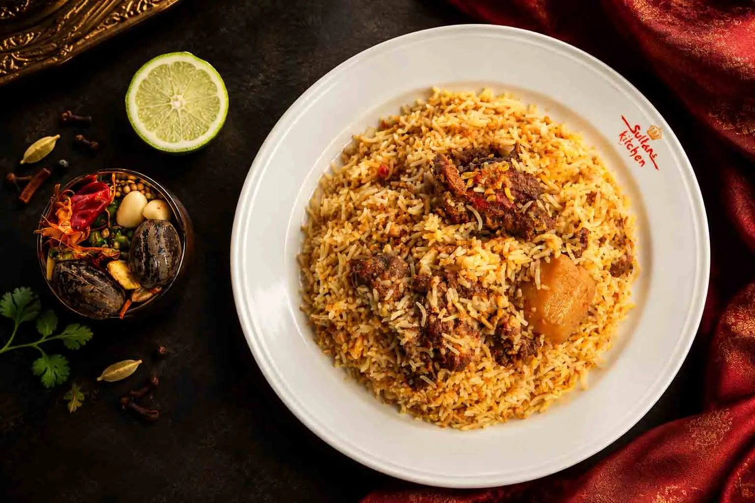 Traditional Bangladeshi biryani with fragrant rice, spiced meat, and potato served on a plate.