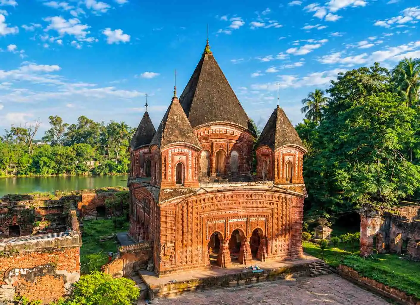 Historic Govinda Temple in Puthia, Rajshahi, Bangladesh, featuring ornate terracotta brickwork, multiple towers, and traditional Bengal temple architecture.