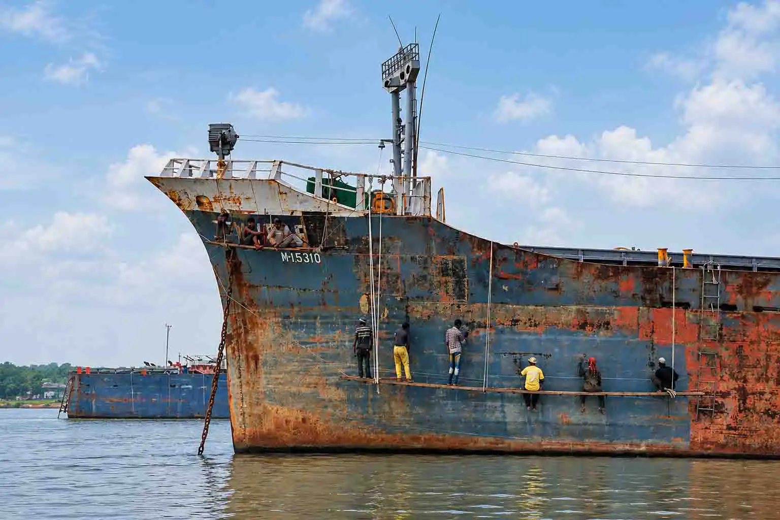 Photographers can capture a weathered cargo ship and workers repairing its hull along a river in Bangladesh.